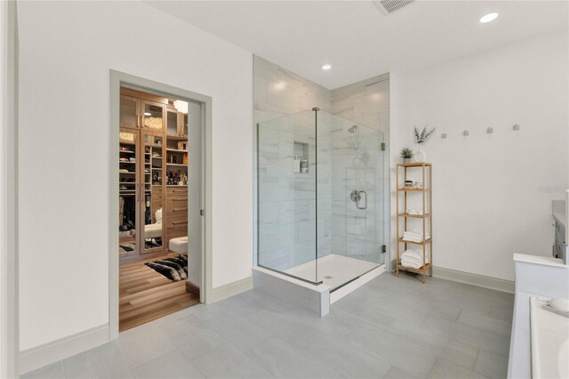 bathroom with a shower with shower door and tile patterned floors