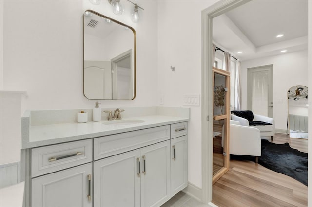 bathroom with vanity and hardwood / wood-style flooring