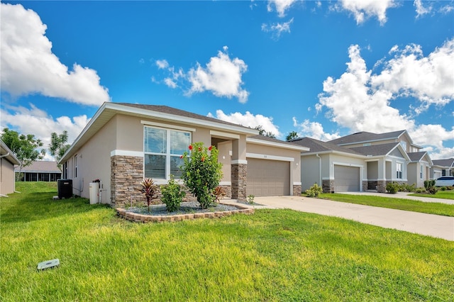 view of front of house featuring a garage, central AC unit, and a front lawn