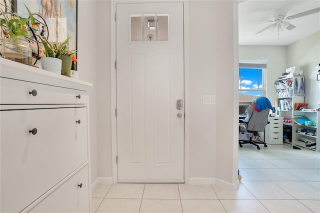 interior space featuring light tile patterned floors and ceiling fan