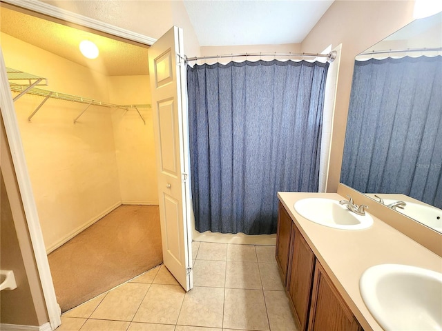 bathroom with vanity, tile patterned flooring, and curtained shower