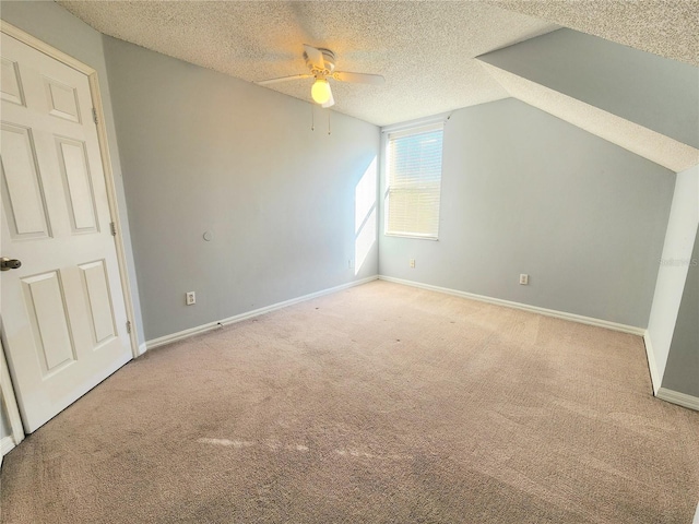 bonus room with ceiling fan, lofted ceiling, carpet flooring, and a textured ceiling