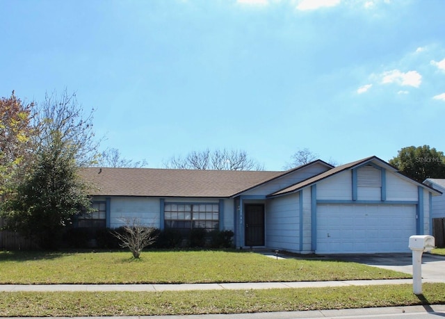 ranch-style house with a garage and a front lawn