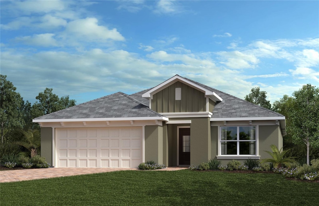 ranch-style house featuring an attached garage, decorative driveway, a front lawn, board and batten siding, and stucco siding