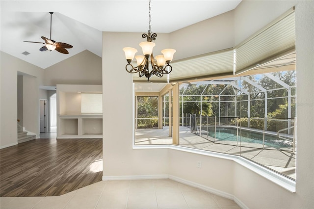 unfurnished dining area with wood-type flooring, vaulted ceiling, and ceiling fan