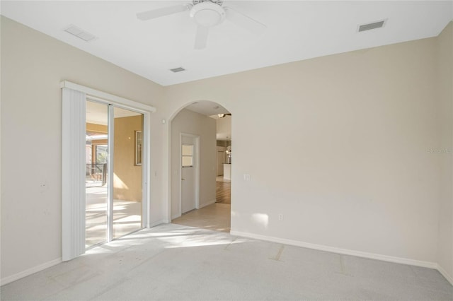 spare room featuring light carpet and ceiling fan