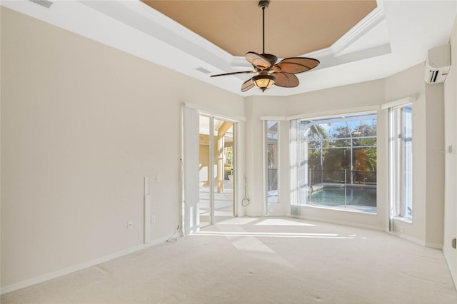 unfurnished room with a wall mounted AC, light colored carpet, ceiling fan, a raised ceiling, and crown molding