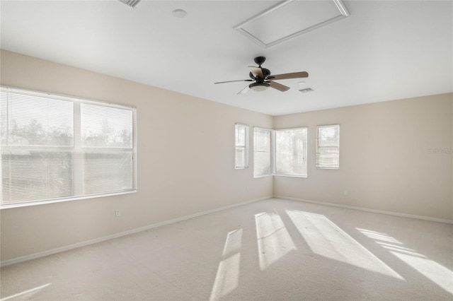 carpeted spare room with ceiling fan