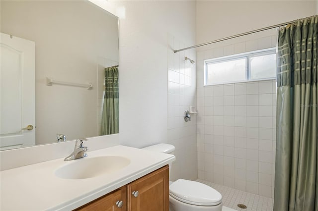 bathroom featuring vanity, toilet, and walk in shower