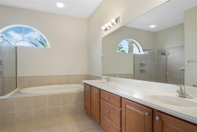 bathroom featuring tile patterned flooring, vanity, and shower with separate bathtub