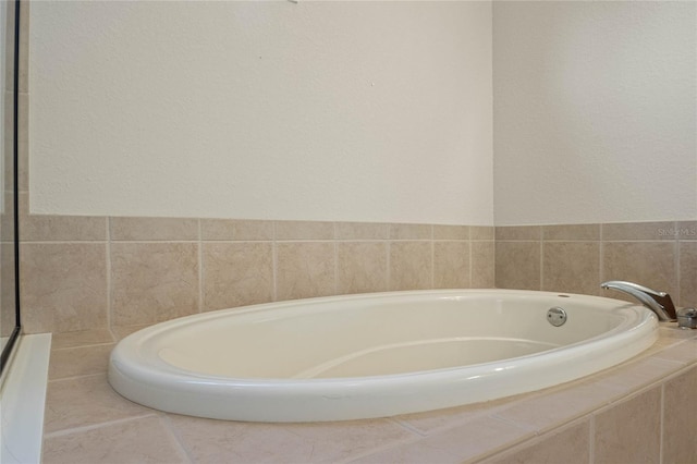 bathroom featuring tiled bath