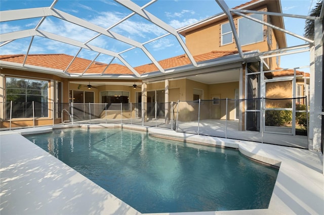 view of pool with ceiling fan, a lanai, and a patio