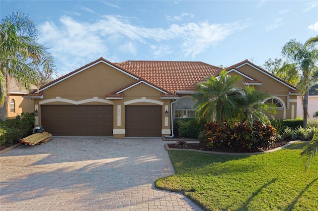 view of front facade with a garage and a front lawn