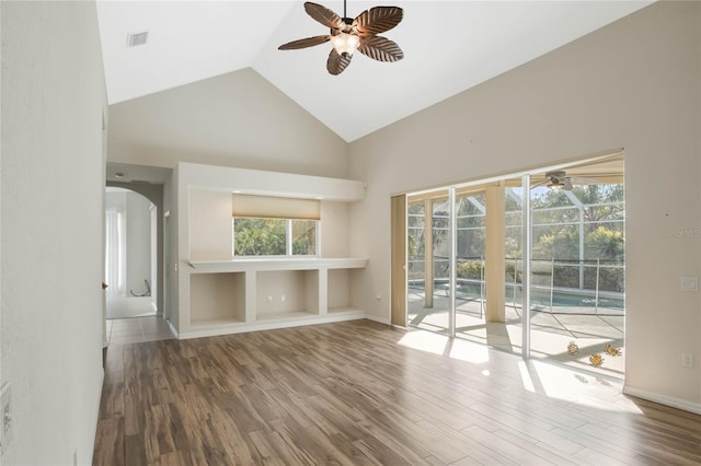 unfurnished living room with hardwood / wood-style flooring, high vaulted ceiling, and ceiling fan