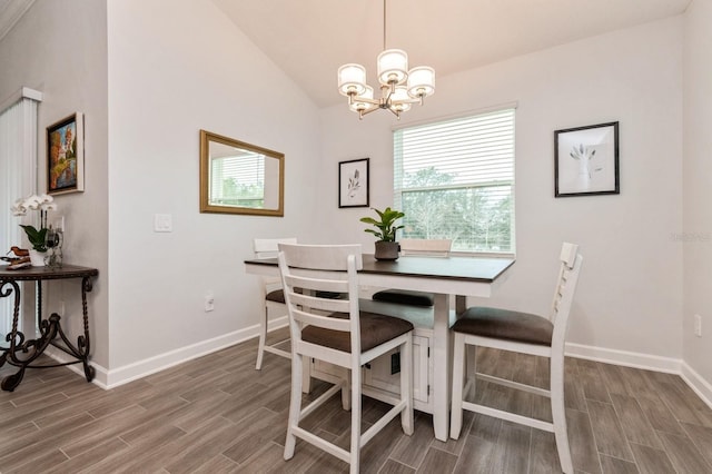 dining area with vaulted ceiling, baseboards, a notable chandelier, and wood tiled floor