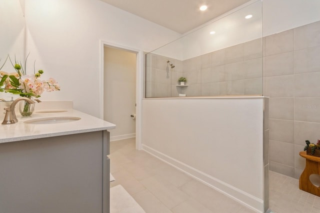 full bath with a walk in shower, double vanity, a sink, and recessed lighting