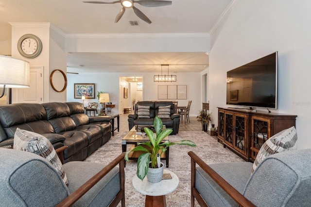 living room featuring ceiling fan with notable chandelier, visible vents, baseboards, and ornamental molding