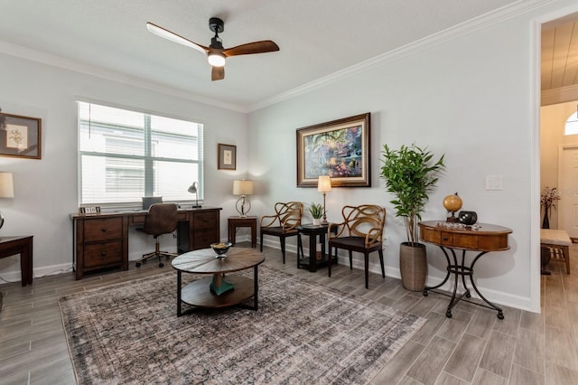 sitting room featuring a ceiling fan, wood tiled floor, crown molding, and baseboards