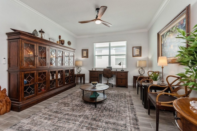 sitting room with wood tiled floor, ceiling fan, and crown molding