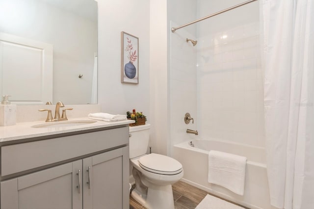 full bath with shower / bath combo, vanity, toilet, and wood finished floors