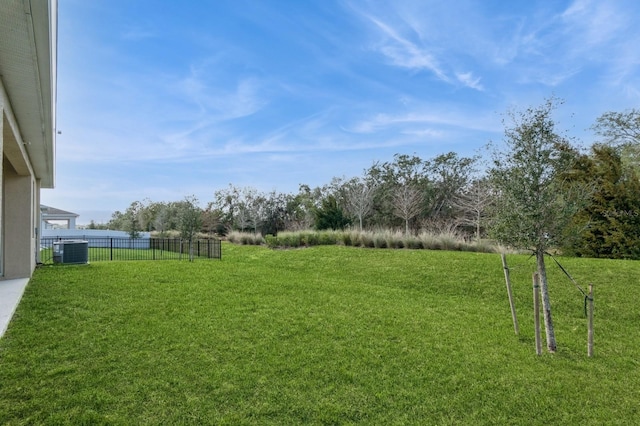 view of yard with fence and cooling unit