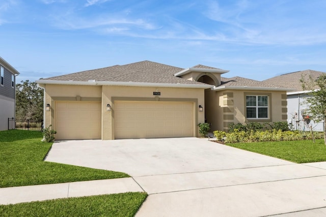 prairie-style home featuring a garage, a front yard, and stucco siding