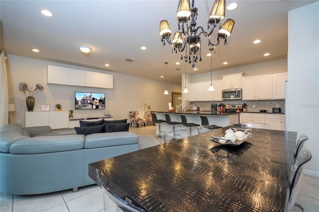 tiled dining area with a notable chandelier