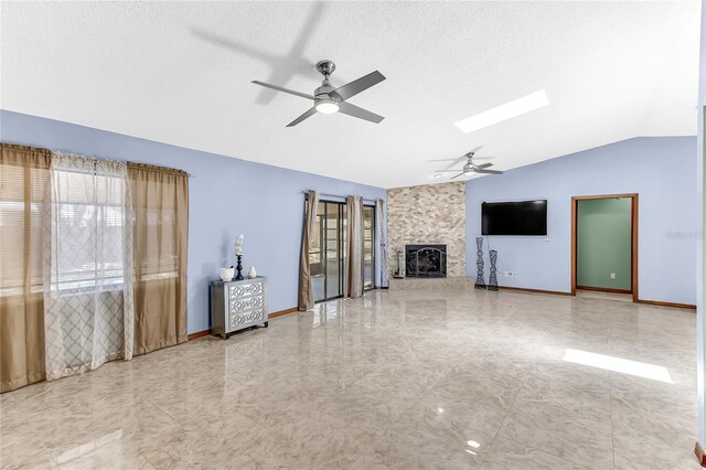 3547 Medford Rd, Casselberry, FL 32707 - unfurnished living room with vaulted ceiling, a ceiling fan, a large fireplace, and a skylight