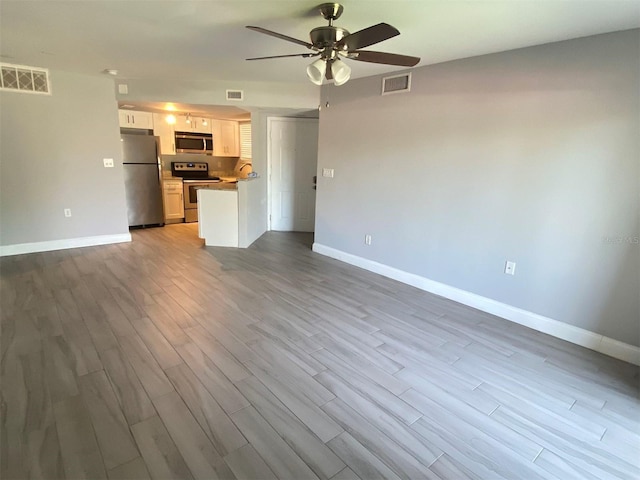 unfurnished living room with ceiling fan and light hardwood / wood-style floors