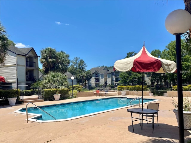 view of swimming pool with a patio area