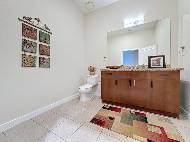 bathroom featuring vanity, tile patterned floors, and toilet