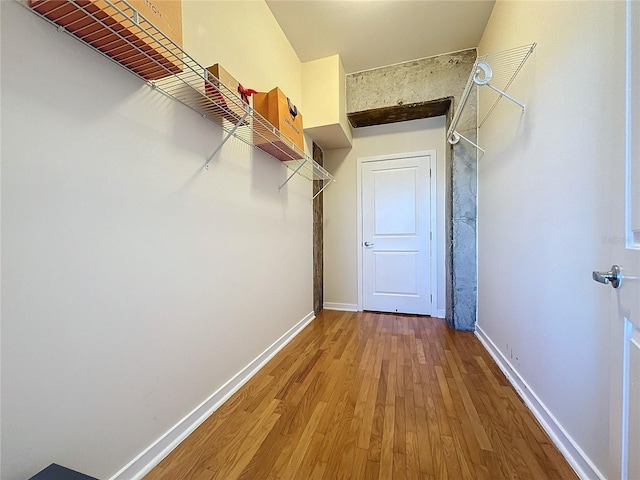 walk in closet with hardwood / wood-style floors