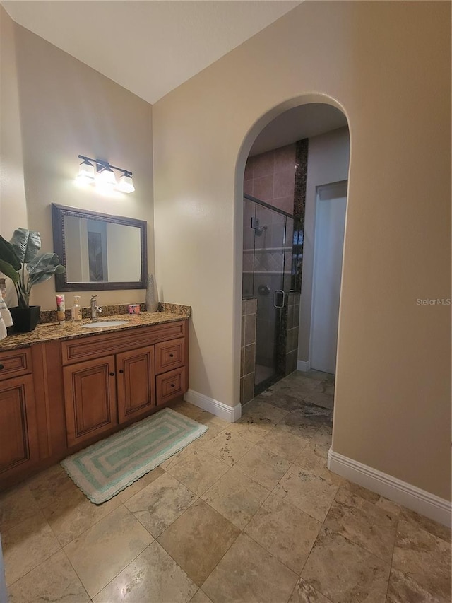 bathroom with vanity and a shower with shower door