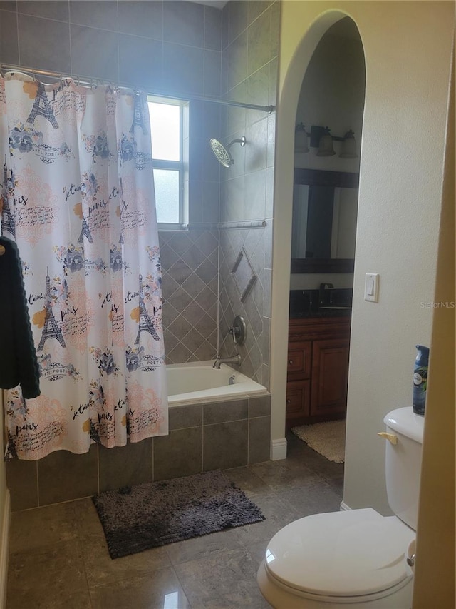 bathroom with tile patterned flooring, shower / tub combo, and toilet