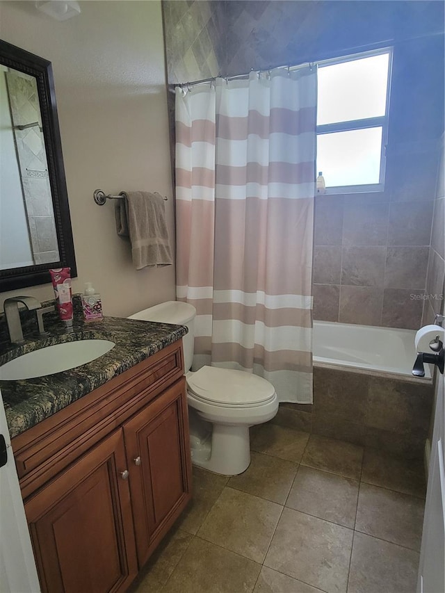 full bathroom with vanity, toilet, tile patterned flooring, and shower / bath combo with shower curtain