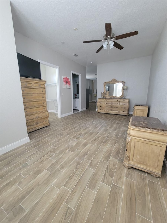 sitting room with a textured ceiling and ceiling fan