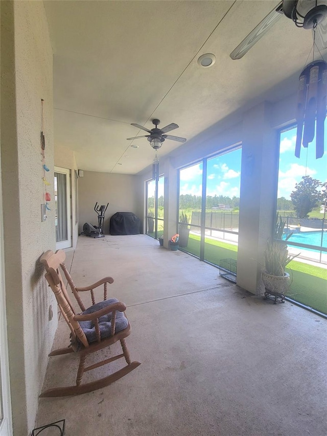 sunroom / solarium with ceiling fan and plenty of natural light