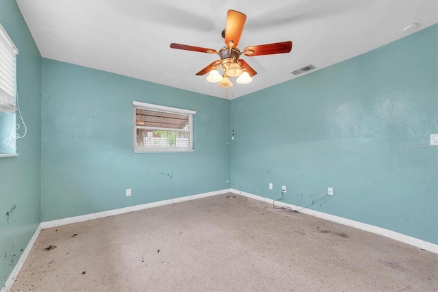 empty room with ceiling fan and carpet flooring