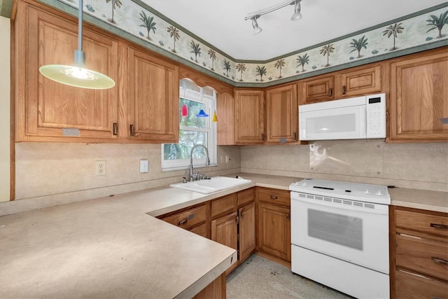 kitchen featuring sink, white appliances, hanging light fixtures, and backsplash