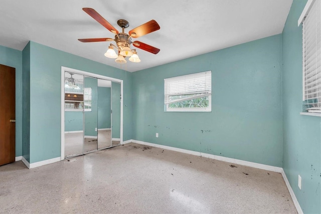 unfurnished bedroom featuring ceiling fan and a closet