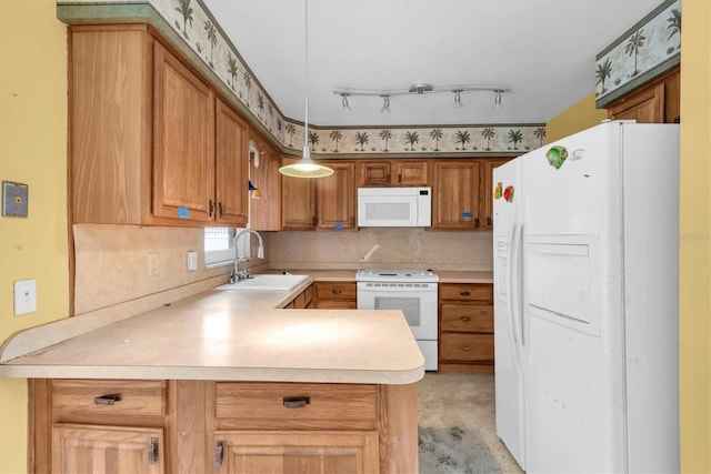 kitchen with sink, decorative backsplash, hanging light fixtures, kitchen peninsula, and white appliances