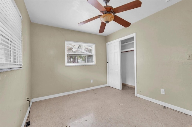 unfurnished bedroom with ceiling fan and a closet