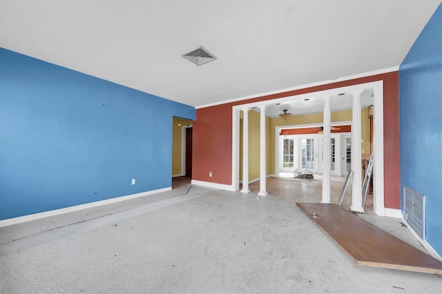 unfurnished living room featuring crown molding, decorative columns, and french doors