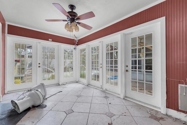 unfurnished sunroom with ceiling fan