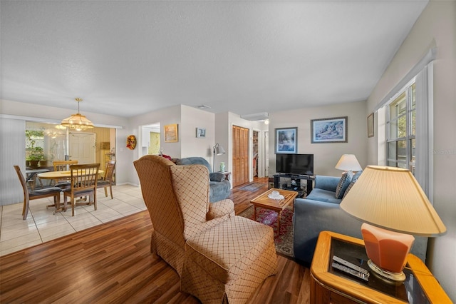 living area with a textured ceiling and light wood-style floors