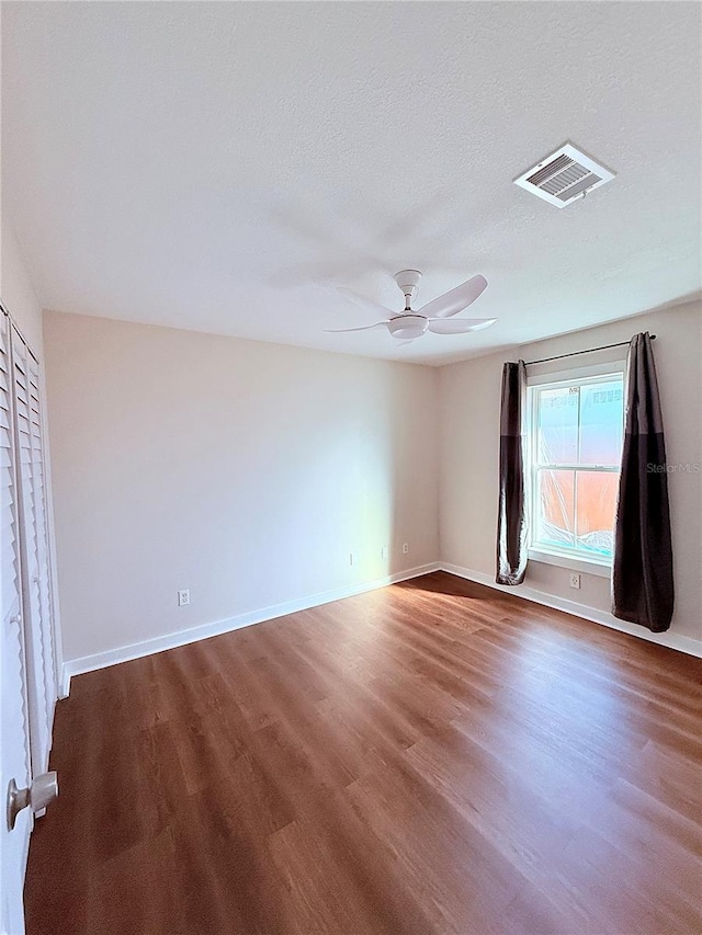 spare room with wood-type flooring, a textured ceiling, and ceiling fan