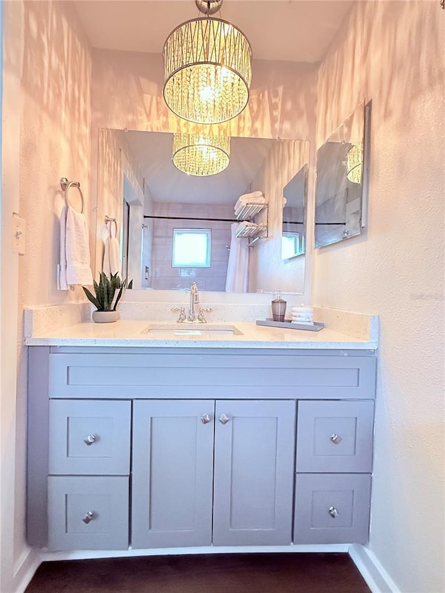 bathroom featuring vanity and a notable chandelier