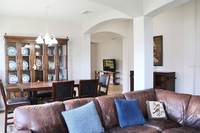 living room with hardwood / wood-style floors and a chandelier