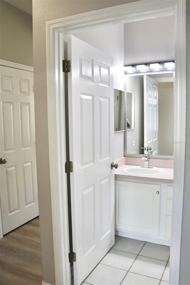 bathroom with tile patterned floors and vanity