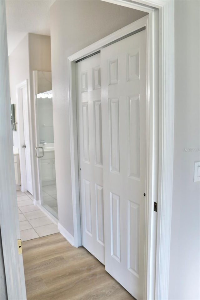 corridor with light hardwood / wood-style flooring